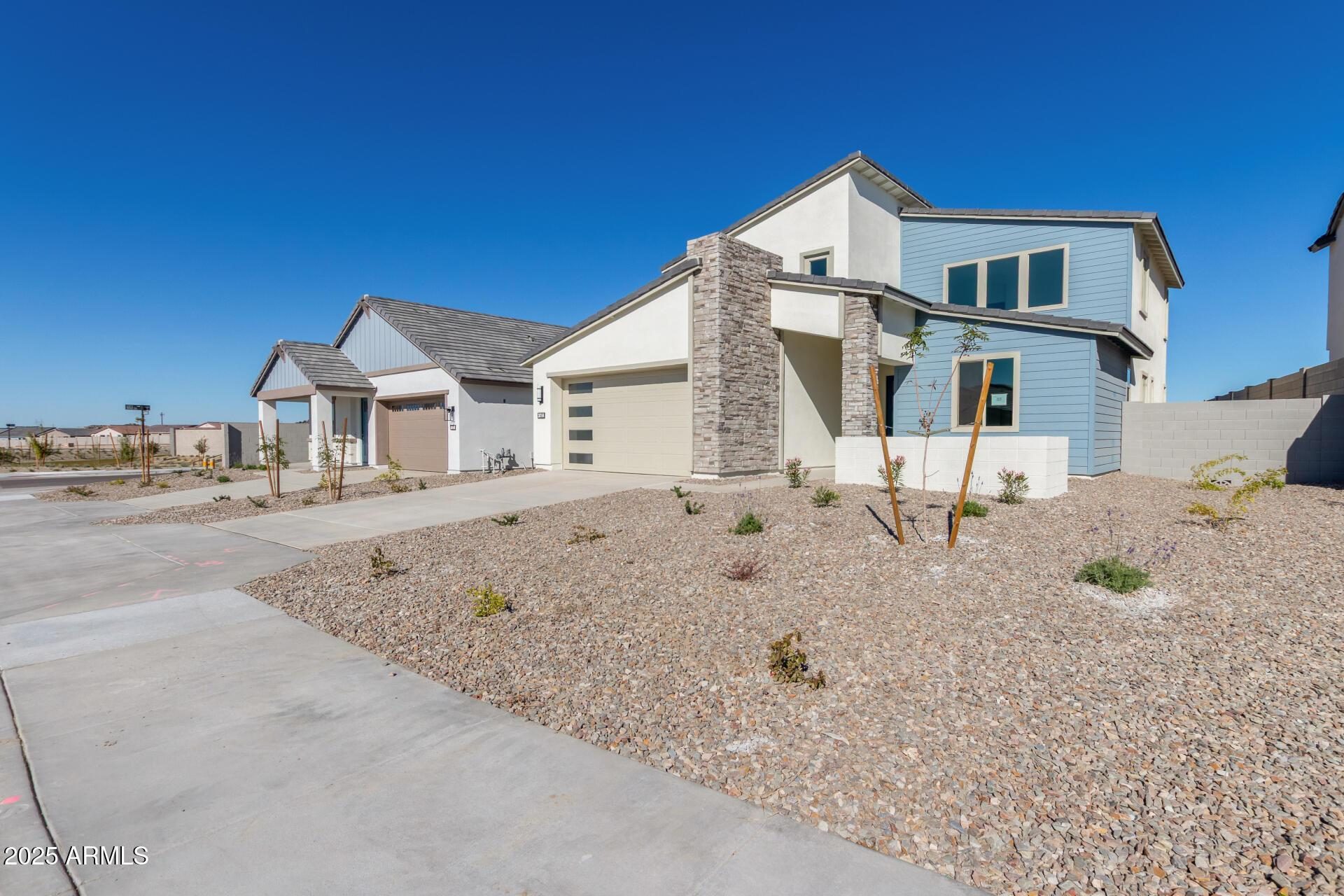 New two-story and single-story homes with desert landscaping in Buckeye Arizona for a Teravalis model home tour guide