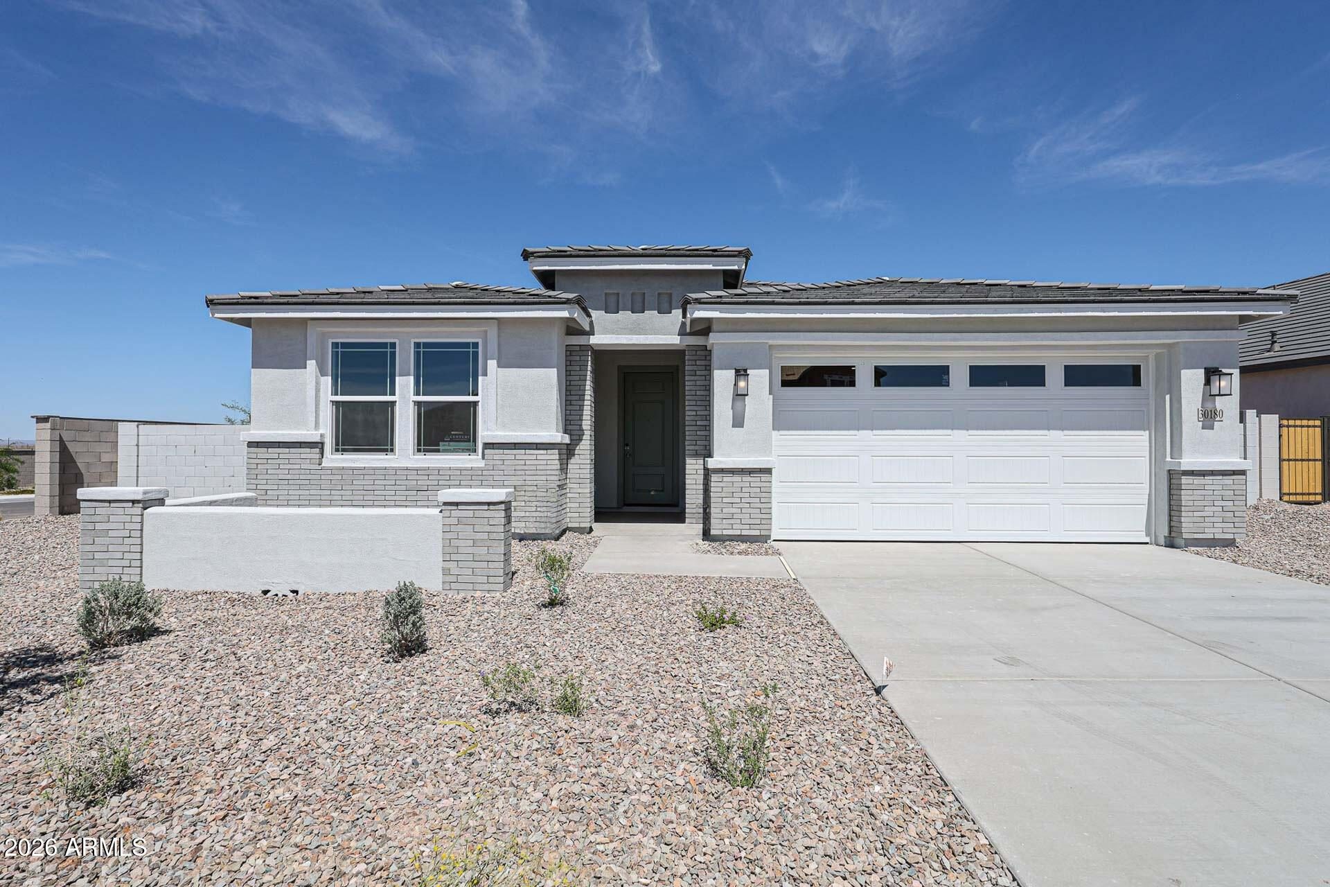 Single-story home with a white garage and gravel landscaping, illustrating this Teravalis move-in ready homes guide